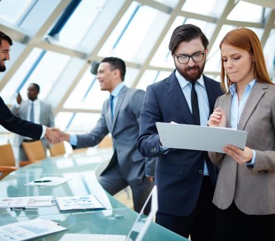 Two,Business,People,Discussing,Data,Or,Planning,Work,On,Background